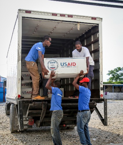 Workers offload relief commodities at a warehouse in Port-au-Prince, Haiti during USAID's Hurricane Matthew response. 