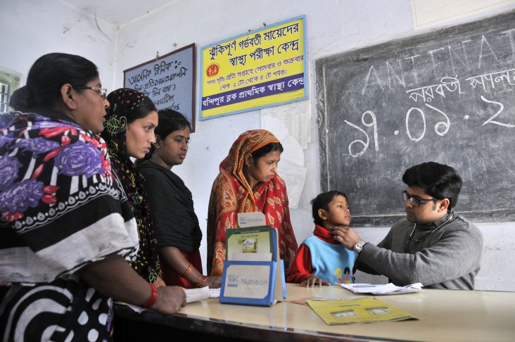 In a remote village of Bandipur, West Bengal, India, women and children line up for examination by a single junior doctor at a block level health care center.