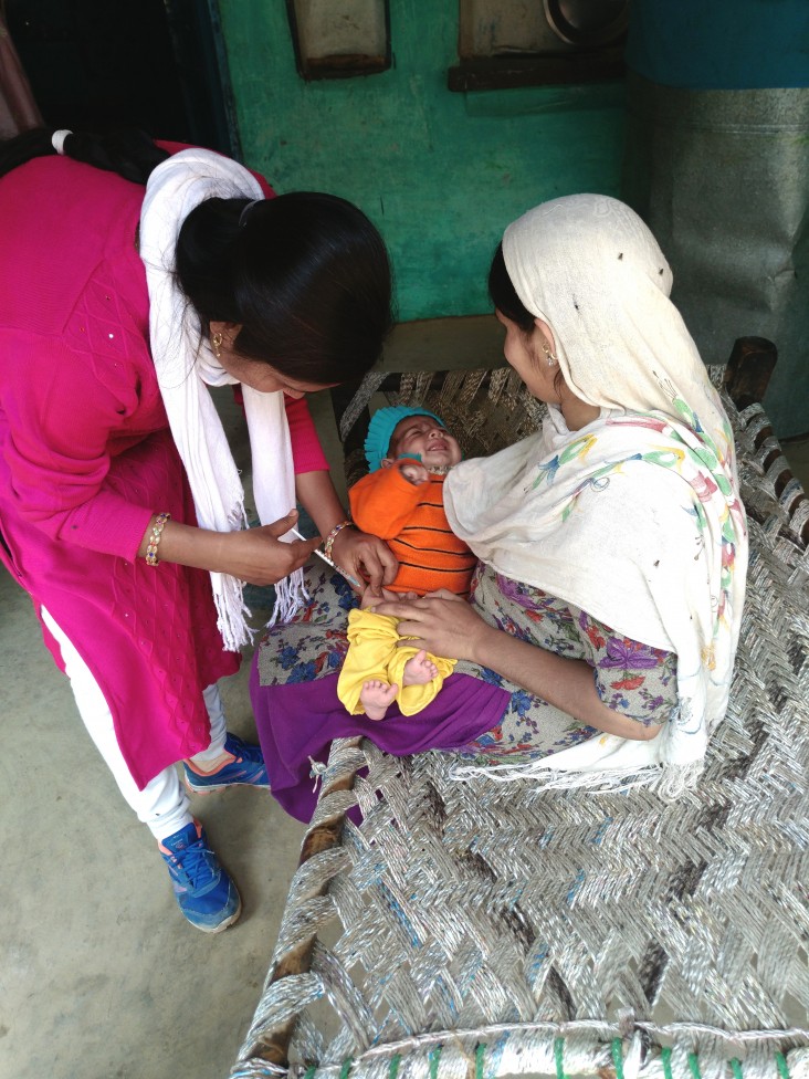 Auxiliary nurse midwife Anju Chauhan administers vaccine to an infant in the Haridwar district of Uttarakhand state.