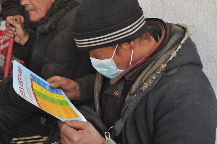 A person at risk reads a brochure about TB during a mass TB testing event in Bishkek, Kyrgyzstan, as part of World TB Day.