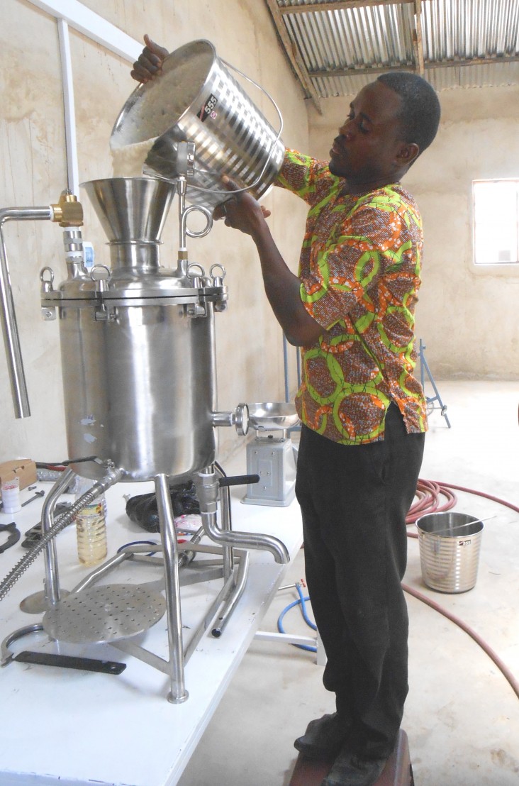 Ground soybean mash is poured into the SoyCow cooker for processing into soy milk at the Savanna Agricultural Research Institute