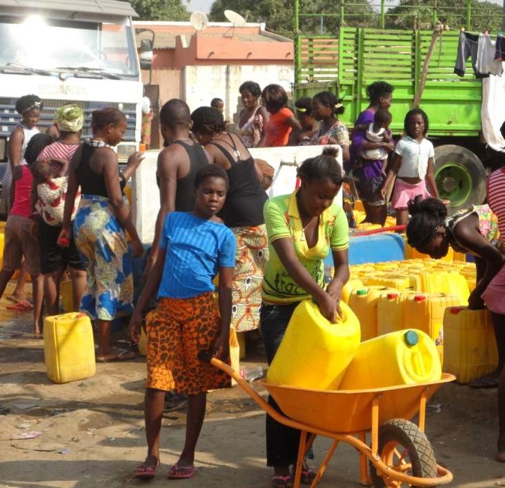 Angolan girls collect water from a USAID-funded water point in Cazenga, Luanda Province