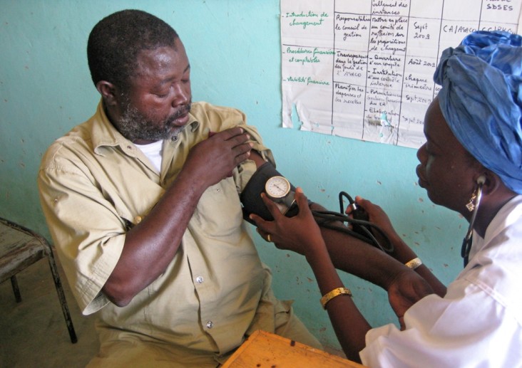 Photo of a man getting his blood pressure taken.