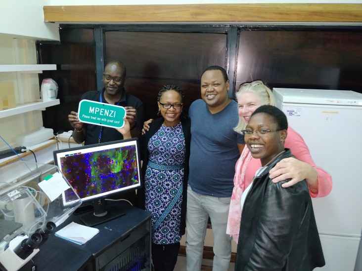 The young scientists named the microscope placed at KAVI-ICR "Mpenzi" meaning "favorite one" in Swahili. Pictured from right to left: Patrick Mwaura, Dr. Marianne Mureith, Robert Lang'at, USAID’s Margaret McCluskey, and Akiso Matrona Mbendo."