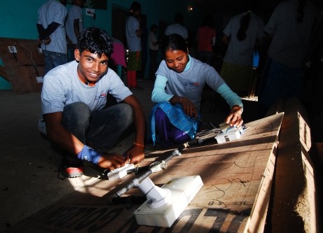 Image of two teenagers doing a hands-on electrician training in Dhangadi, Nepal
