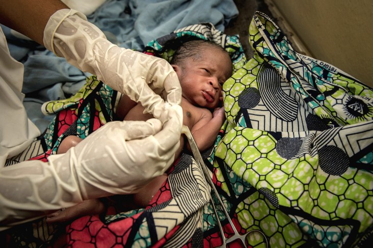 A newborn’s umbilical cord is cut in a Nigerian hospital.