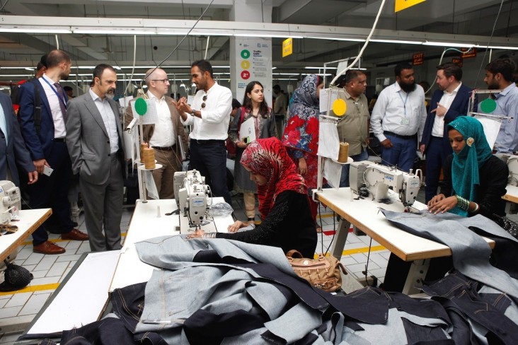 USAID and U.N. Development Program representatives visit a denim factory in Karachi that has partnered with the Youth Employment Project to hire trainees.