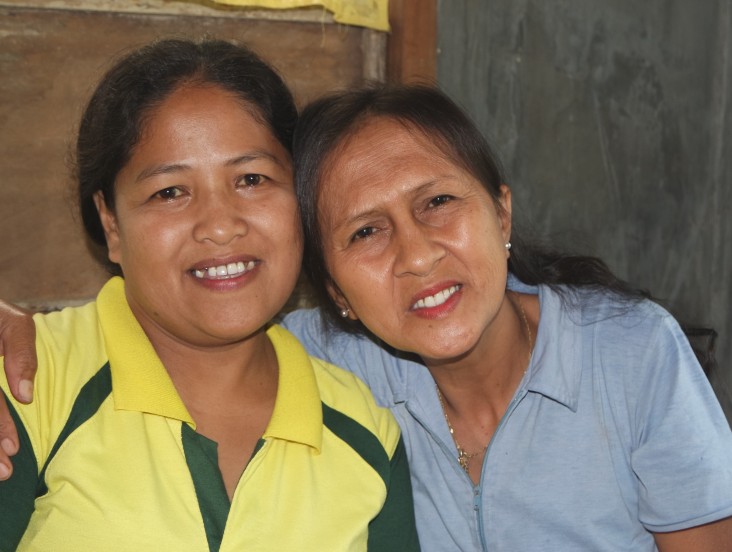Estrellita Apale, right, embraces village health worker Jocelyn Canania.