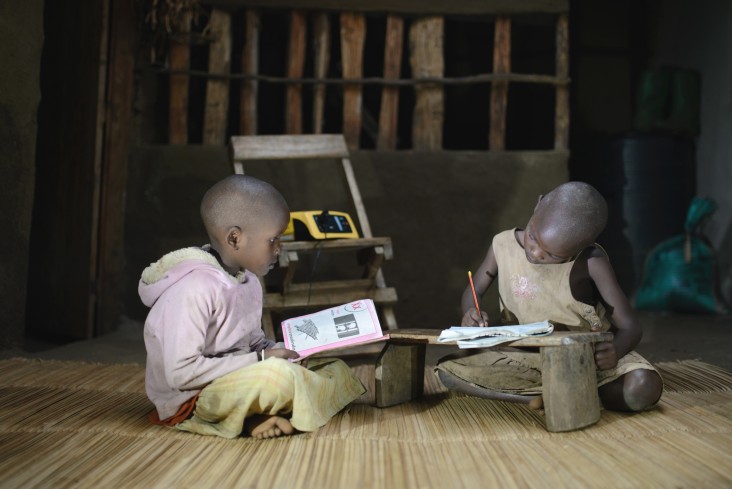 Two students use their Fenix-powered lights to study.