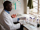 A lab technician working on test tubes
