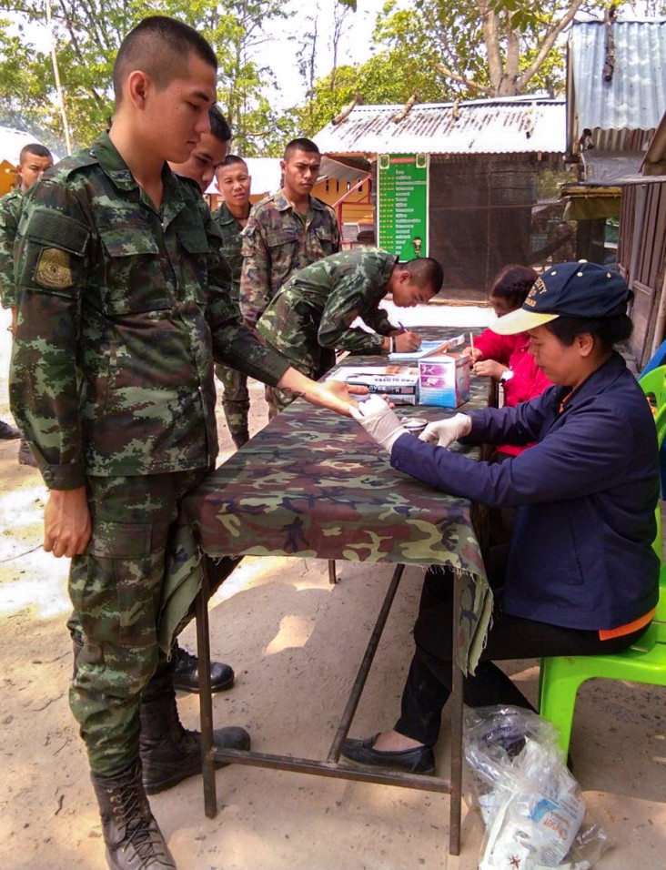 Kanyarat Lausatianragit, right, conducts a mobile malaria clinic for members of the Royal Thai Army on the border between Thailand and Cambodia.