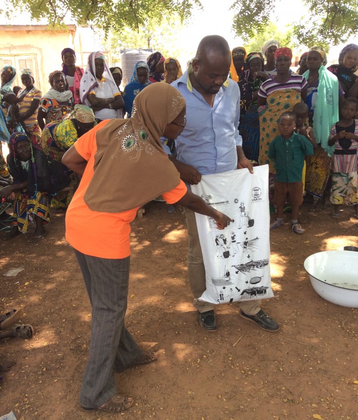 Catholic Relief Services agricultural program and Ministry of Agriculture officers provide soybean agronomic extension to recipients of the soybean success kits in northern Ghana.