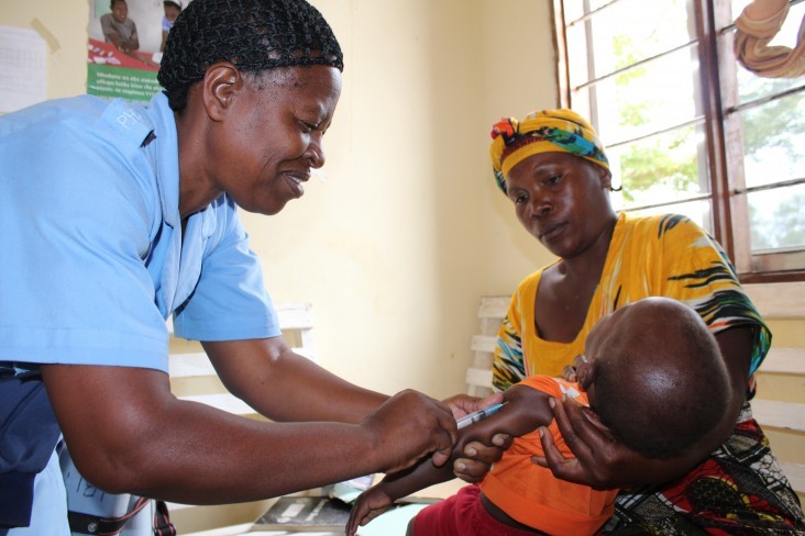 A health provider in Tabora, Tanzania gives a child an immunization shot.