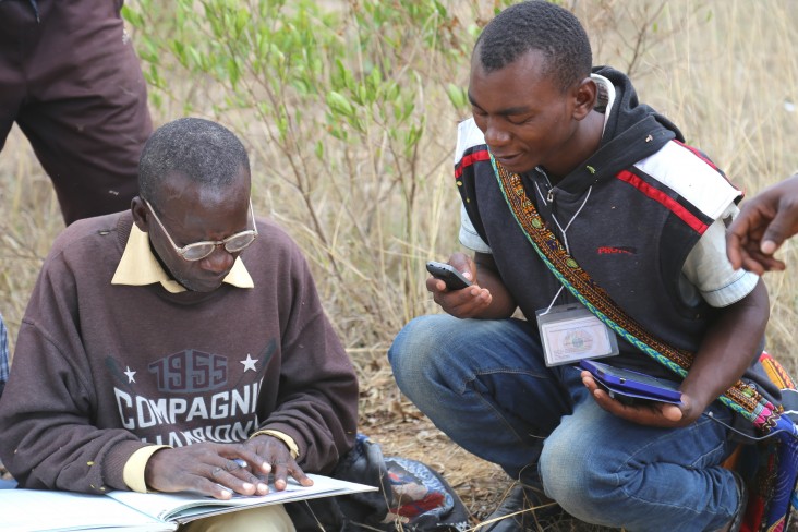 Gaspar Bangi, right, cross-checks data with an adjudicator from the Kiponzelo field surveying team.