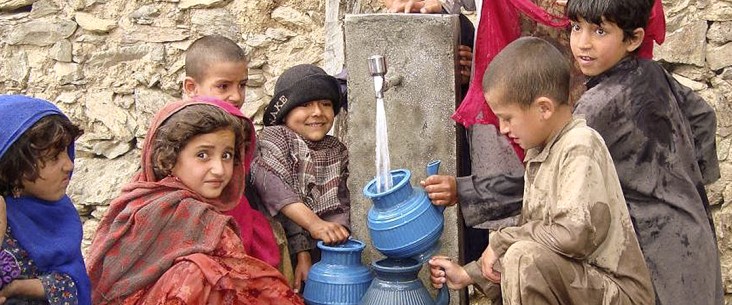 A group of children gather water