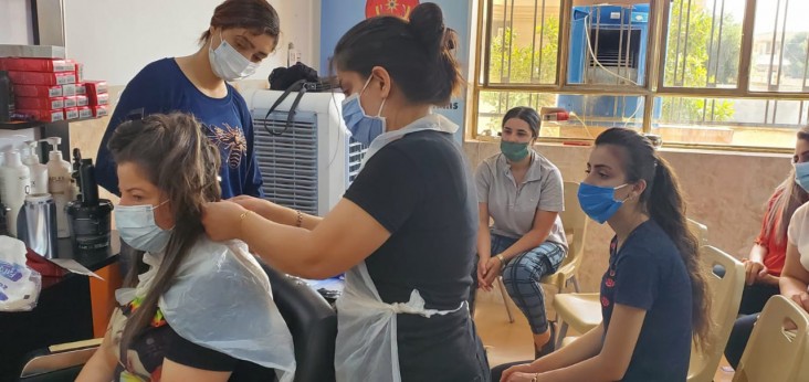 Women in northern Iraq attend a cosmetology training course