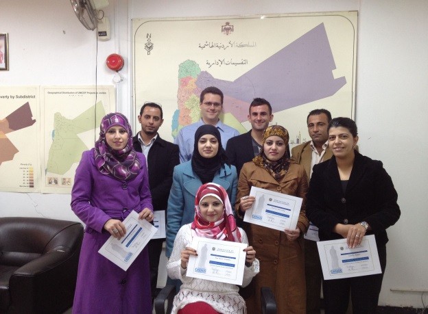 DOS staff members after receiving a completion certification for “Introduction to GIS” training course