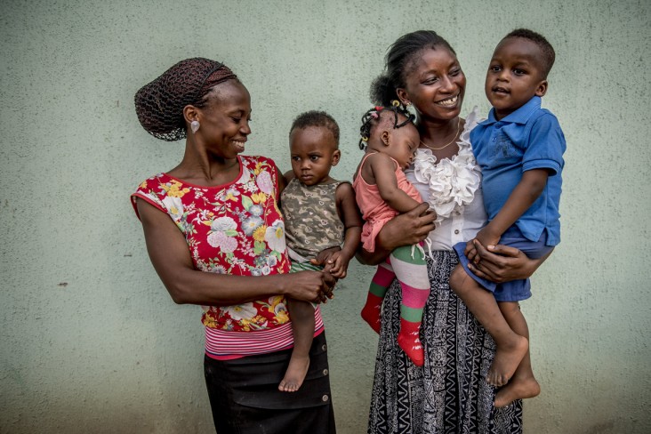 Mothers and small business owners, Hanna Achika, 27 (left) and Victoria Titus, 25 (right) hold their children at the Peace Sanctuary in Lokoja, Nigeria.