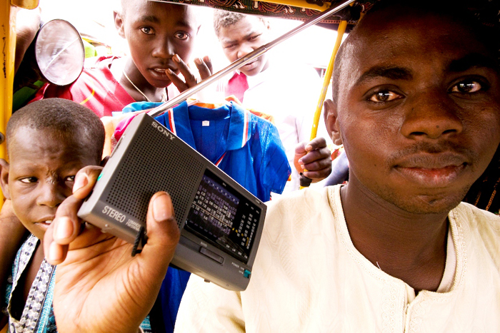 A minicab driver listens to a radio broadcast in a market in Abeche, Chad (2009)