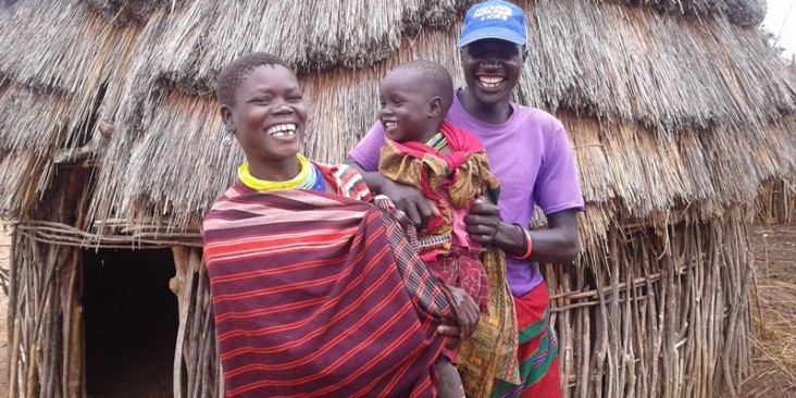 A small family in Uganda - father, mother and baby.