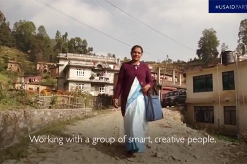 Video screenshot image: Woman walking down road