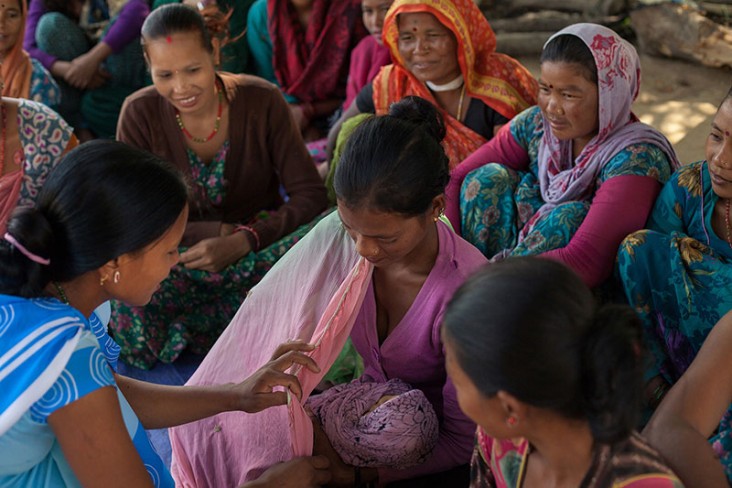Female Community Health Worker Jharana Kumari Tharu councils a group of women, including expectant mothers.
