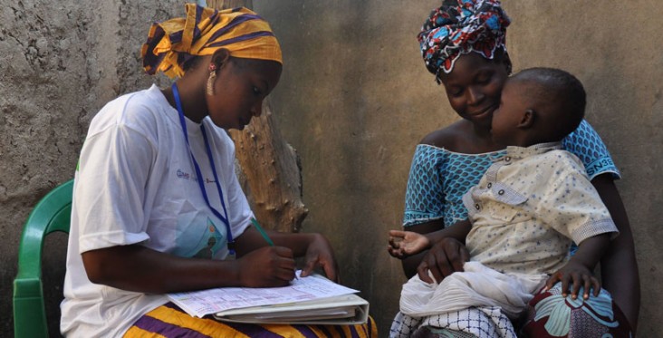 A community health worker examines a patient in Kita, Mali