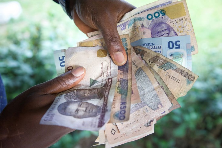 A close-up of local currency, Naira bills, being exchanged at a clinic. Health care is  still costly for some in Nigeria, although the HFG Project seeks to improve accessibility.