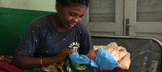 Marriboa, pictured with her two-day old son Pascal, receives counseling on breastfeeding after delivering at a USAID-supported facility in Madagascar.