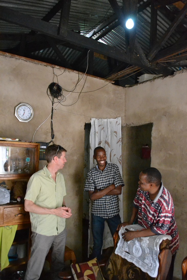 OPIC’s Chief of Staff John Morton in the home of a customer of Off-Grid Electric’s innovative pay-as-you-go home solar service. 