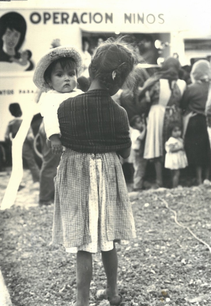 A historical photo of a woman holding a child