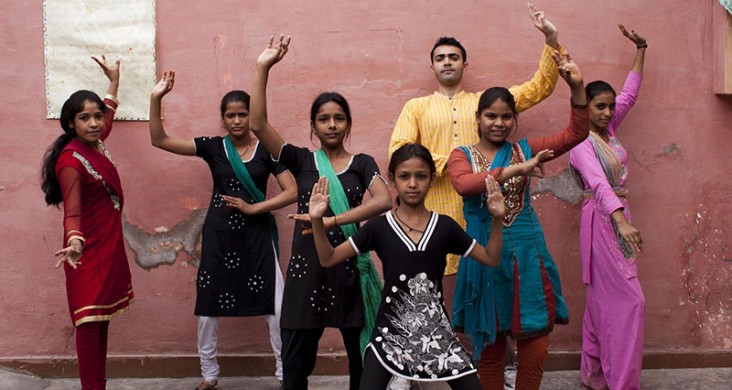 These youth in the Perna community are posing in a traditional bhangra folk dance stance. The dance form allowed the children to gain a sense of autonomy, companionship and group solidarity. 