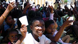 Photo of children in Namibia receiving a daily cup of nutritious yogurt