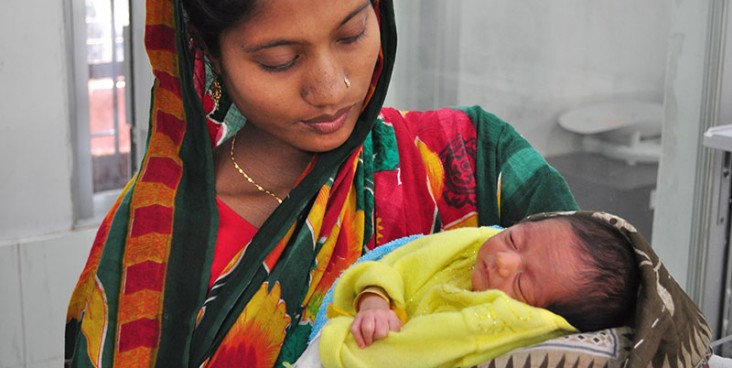 A woman holds her newborn baby