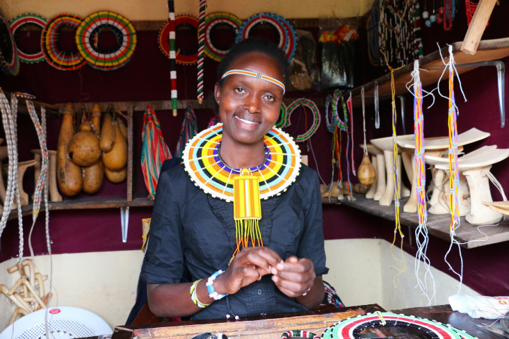 A young kenyan woman entrepreneur in her shop.