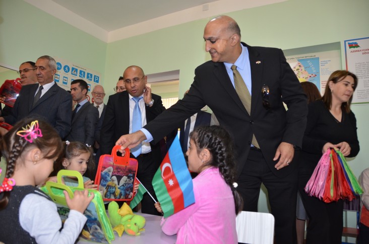 The Mission Director presents gifts to children during the tour of the renovated kindergarten.