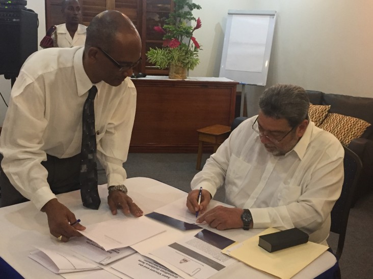 Prime Minister and Minister of Legal Affairs of St. Vincent and the Grenadines Dr. Ralph Gonsalves  signs documents to endorse the CariSECURE Project and implement the Citizen Security Toolkit. 
