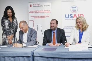 USAID and Coca-Cola representatives sign an agreement on partnership