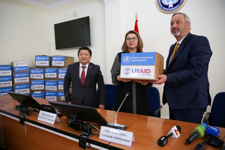Vice Prime Minister Omurbekova receives the symbolic box of equipment from USAID Mission Director Gary Linden.