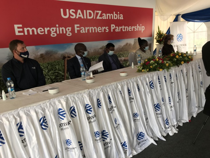 Representatives from USAID, Corteva, Global Communities, and John Deere sit at the high table during the launch of the Emerging Farmers Partnership Program in Lusaka on December 17