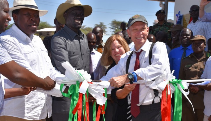U.S. Ambassador to Kenya, Robert Godec, cuts the ribbon to official open the Lodwar Livestock Market. With him is USAID’s Deputy Mission Director Heather Schildge, the Governor of Turkana County, Josphat Nanok and the Cabinet Secretary for Arid and Semi-arid Lands Eugene Wamalwa.