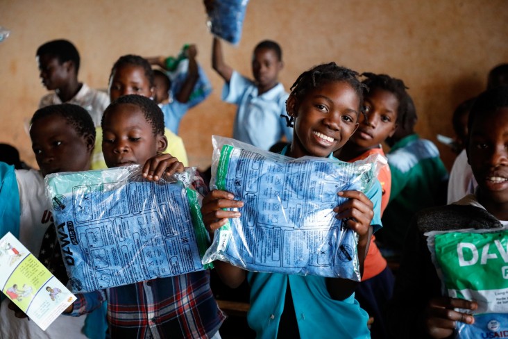 Children holding insecticide treated bednets