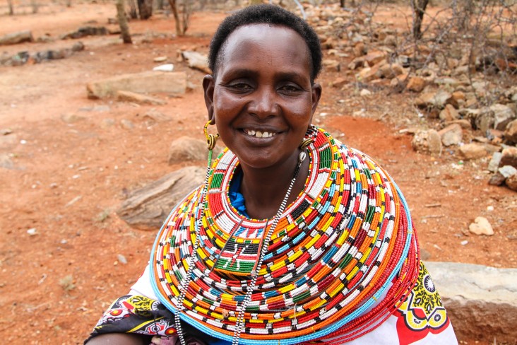 Nalan'gu Lokoloto wearing some of the colorful traditional jewelry helping her make a living.