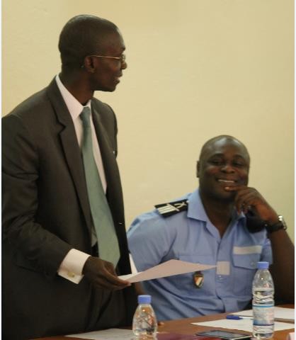 A court officer and a police officer discusses in an office
