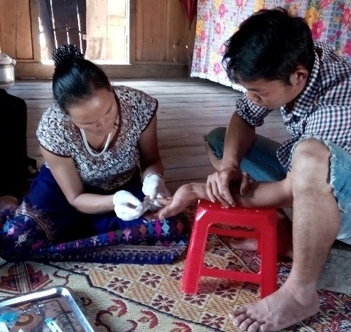 HIV testing being provided in a rural Vietnamese home by a lay provider.