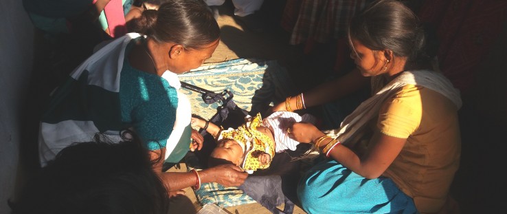 A community health worker prepares to weigh a newborn at his home in the Haridwar district of Uttarakhand state.