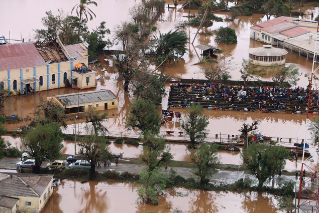 Residents gather stranded on the stands of a stadium in a flooded area of Buzi, central Mozambique, on March 20, 2019, after the passage of cyclone Idai.