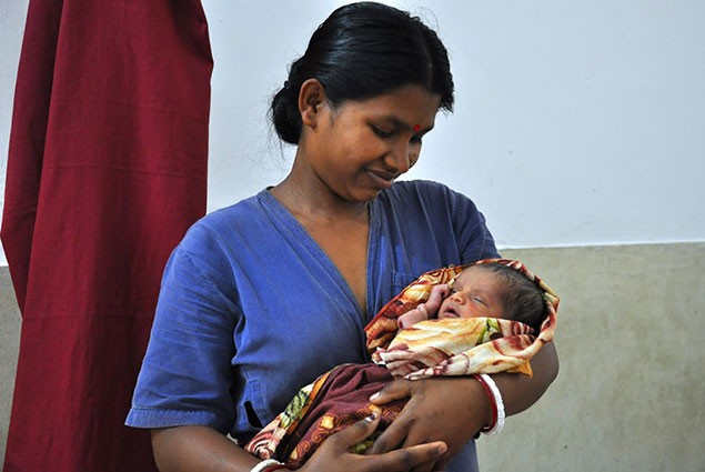 Woman holds a newborn baby