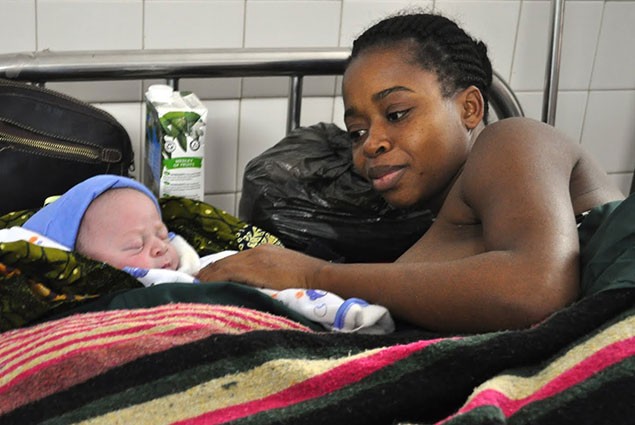 Mother with newborn in health care facility