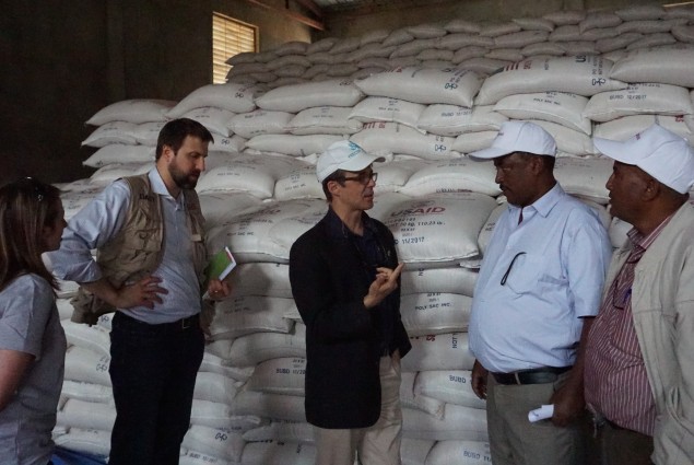 Representatives of USAID partner Relief Society of Tigray (right), describe the food distribution system in Hawzien to USAID Office of Foreign Disaster Assistance Director Jeremy Konydnyk (left) and U.S. Chargé d'Affaires to Ethiopia Peter Vrooman.